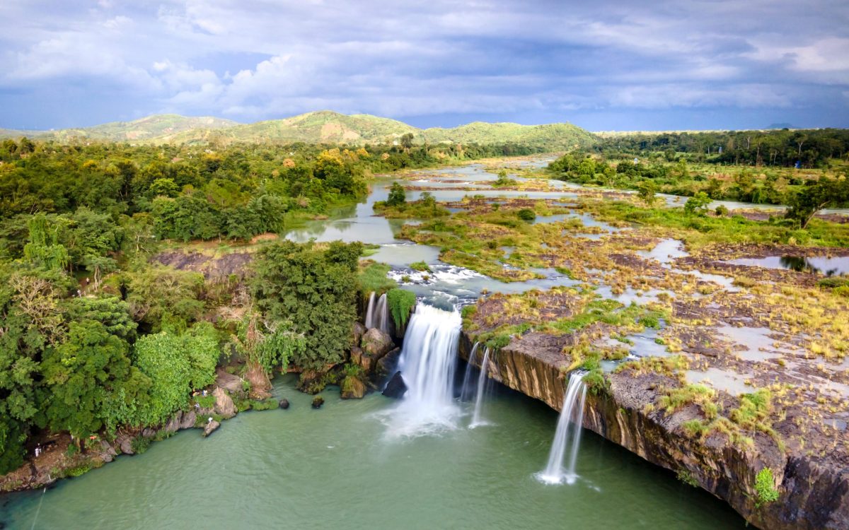 A breathtaking aerial view of Dray Nur Waterfall surrounded by lush greenery in Vietnam.